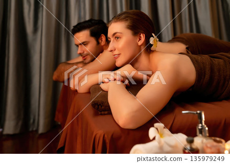 Caucasian couple customer enjoying relaxing anti-stress massage. Quiescent Caucasian couple customer enjoying relaxing anti-stress massage. Quiescent 135979249