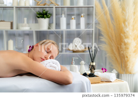Caucasian woman customer enjoying relaxing anti-stress massage. Quiescent Caucasian woman customer enjoying relaxing anti-stress massage. Quiescent 135979374