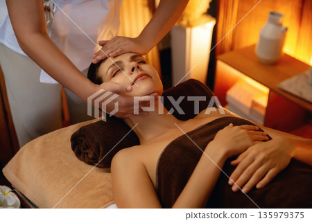 Caucasian woman enjoying relaxing anti-stress head massage. Quiescent Caucasian woman enjoying relaxing anti-stress head massage. Quiescent 135979375
