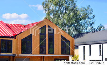 Terraced houses under construction. Housing estate development under construction. Terraced houses under construction. Housing estate development under construction. 135979614