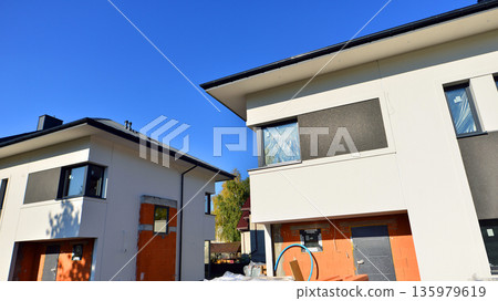 Terraced houses under construction. Housing estate development under construction. Terraced houses under construction. Housing estate development under construction. 135979619