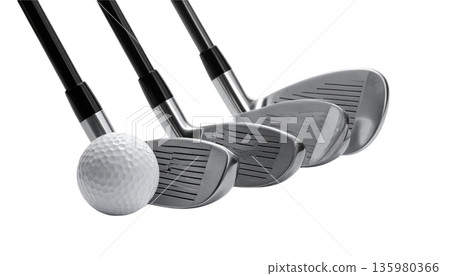 A set of golf clubs and balls, along with a driver and tee, placed on the green grass. A set of golf clubs and balls, along with a driver and tee, placed on the green grass. 135980366