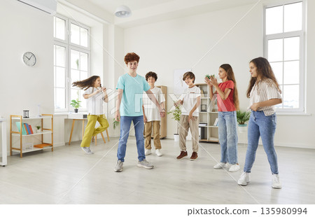 Students Playing Together During Break In School Classroom Students Playing Together During Break In School Classroom 135980994