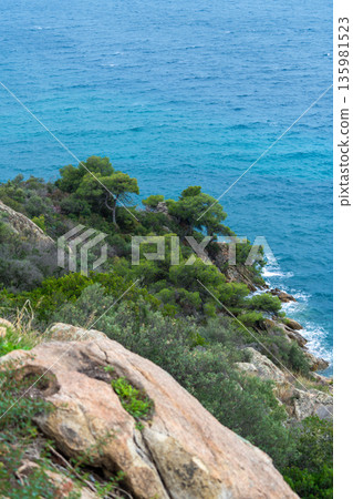high cliff above the sea, summer sea background. View of rocky coastline and blue ocean on a clear day near a cliffside location during afternoon hours high cliff above the sea, summer sea background. View of rocky coastline and blue ocean on a clear day near a cliffside location during afternoon hours 135981523
