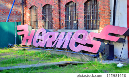 Warsaw, Poland. 6 November 2025. Urban landscape. Old abandoned neon sign with company name: Hermes Warsaw, Poland. 6 November 2025. Urban landscape. Old abandoned neon sign with company name: Hermes 135981658