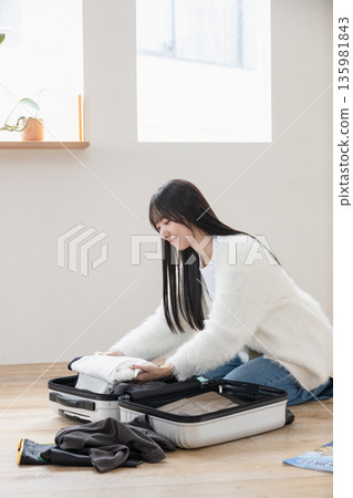 A woman preparing for a trip A woman preparing for a trip 135981843