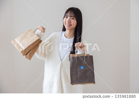 A woman with a shopping bag A woman with a shopping bag 135981880
