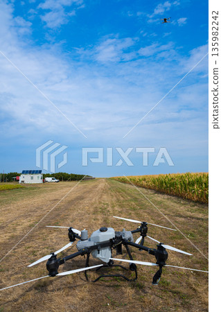 Drone on a rural field preparing for agricultural mapping and aerial inspection Drone on a rural field preparing for agricultural mapping and aerial inspection 135982242