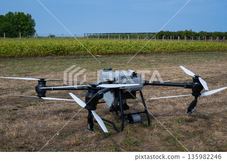 Agricultural drone on a dry field ready for aerial inspection and data capture 135982246