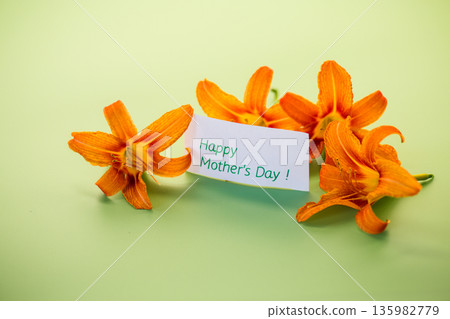 Orange lily flowers with greeting card Orange lily flowers with greeting card 135982779