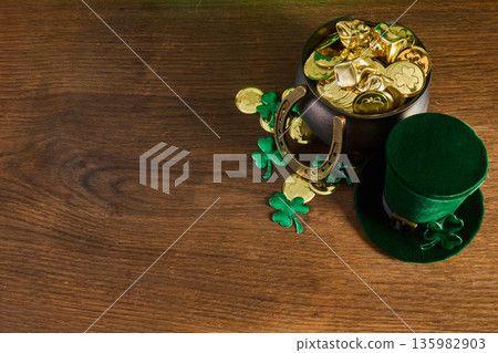 St. Patrick's day pot of gold with shamrocks and leprechaun hat St. Patrick's day pot of gold with shamrocks and leprechaun hat 135982903