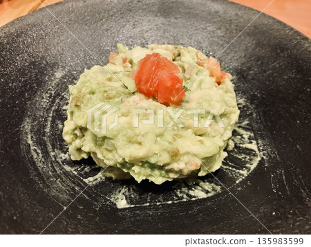 Potato salad on a black plate 135983599