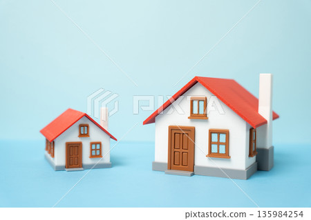 Choosing between a large and a small home. The pros and cons of home size. Buying a larger home for a growing family. Space needs, budget balance and future oriented housing decisions 135984254