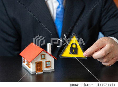 House under lock and key. Property protection. Guarantees and insurance. Asset freezing, house seizure. Real estate risk concept, legal restrictions and safeguarding property from financial threats 135984313