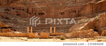 Ruins of the amphitheater of the abandoned city of Petra in Jordan. Ancient remains of the first century AD Nabataean theatre 135984846