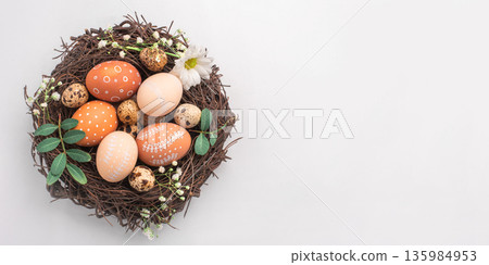 Easter nest with hand-painted eggs on a light background Easter nest with hand-painted eggs on a light background 135984953