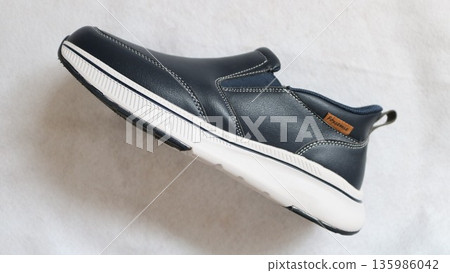 Men's laceless sneakers on a white background 135986042