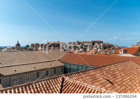 Exploring the stunning rooftops of Old Town Dubrovnik on a clear sunny day. Exploring the stunning rooftops of Old Town Dubrovnik on a clear sunny day. 135986264