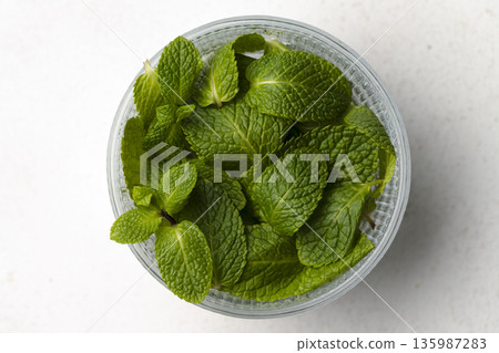 Fresh Mint Leaves in Glass Bowl Fresh Mint Leaves in Glass Bowl 135987283