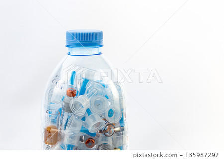 Used insulin syringes in plastic bottle for infectious waste disposal, medical biohazard waste management and safety concept Used insulin syringes in plastic bottle for infectious waste disposal, medical biohazard waste management and safety concept 135987292