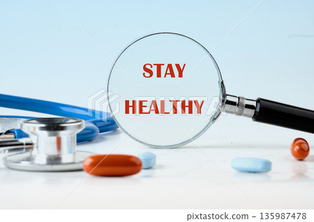 A magnifying glass sharply reveals the powerful message Stay Healthy A magnifying glass sharply reveals the powerful message Stay Healthy 135987478