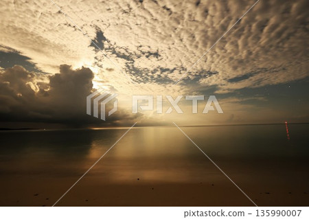 The beach of Kumejima, Okinawa on a quiet night with the moonlight reflecting off 135990007