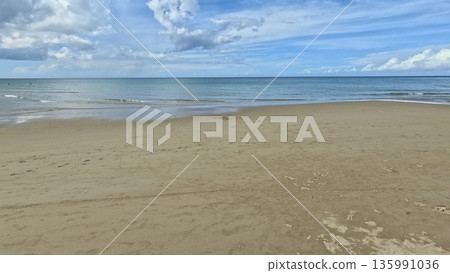 Tranquil beach with sandy shore and a calm ocean under a blue sky in Sugar Beach in Sipalay, Negros Occidental, Philippines Tranquil beach with sandy shore and a calm ocean under a blue sky in Sugar Beach in Sipalay, Negros Occidental, Philippines 135991036