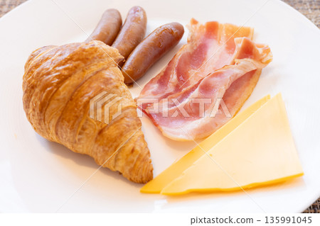 Delicious croissant, bacon, sausage and cheese breakfast 135991045