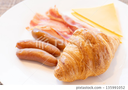 Delicious croissant, bacon, sausage and cheese breakfast 135991052