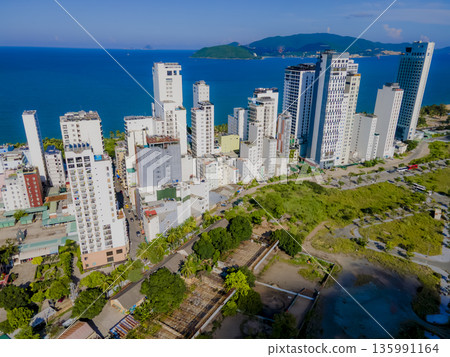 Flying over a coastal city. 135991164