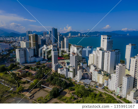 Flying over a coastal city. 135991167