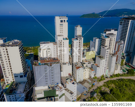 Flying over a coastal city. Flying over a coastal city. 135991169