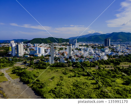 Flying over a coastal city. Flying over a coastal city. 135991170