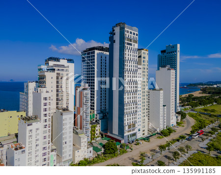 Flying over a coastal city. 135991185