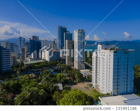 Flying over a coastal city. 135991186