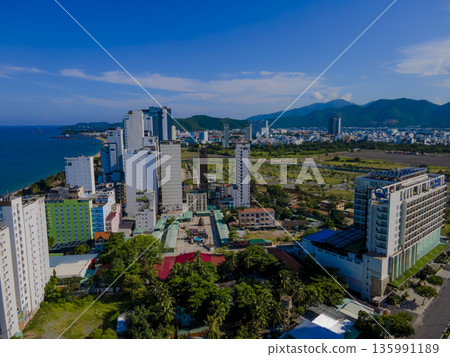 Flying over a coastal city. Flying over a coastal city. 135991189