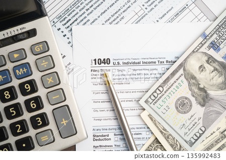 Tax form 1040 U.S. Individual Income Tax Return with dollar banknotes money. Tax form 1040 U.S. Individual Income Tax Return with dollar banknotes money. 135992483