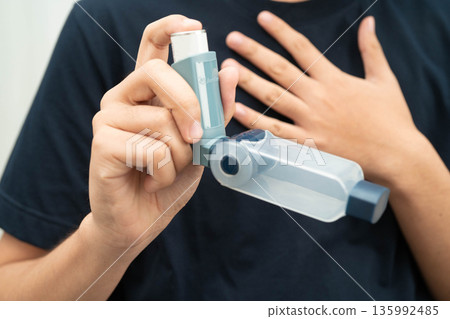 Asthma and chronic obstructive pulmonary disease COPD, Asian teenage using metered dose inhaler MDI. Asthma and chronic obstructive pulmonary disease COPD, Asian teenage using metered dose inhaler MDI. 135992485