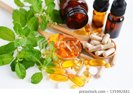 Alternative medicine herbal organic capsule with vitamin E omega 3 fish oil, mineral, drug with herbs leaf natural supplements for healthy good life. 135992881