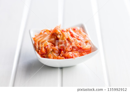 Fermented cabbage. Kimchi. Korean food in bowl on white table. Fermented cabbage. Kimchi. Korean food in bowl on white table. 135992912