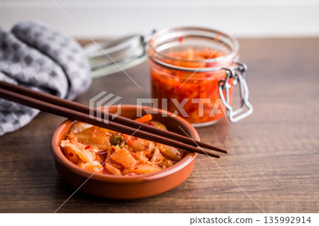 Fermented cabbage. Kimchi. Korean food in bowl on wooden table. Fermented cabbage. Kimchi. Korean food in bowl on wooden table. 135992914