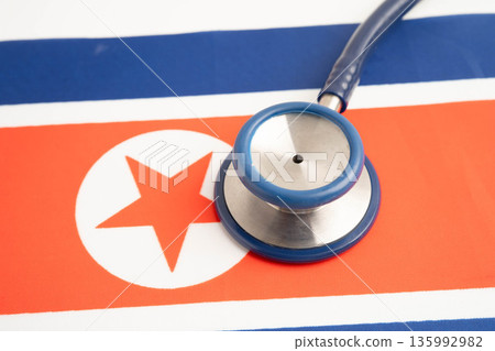 North Korea flag with black stethoscope, Business and finance concept. North Korea flag with black stethoscope, Business and finance concept. 135992982