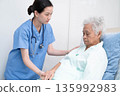 Asian doctor checking and treat elderly woman patient health in hospital. 135992983