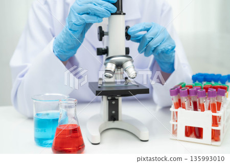 Scientist medical professional use microscope for research in science laboratory. Scientist medical professional use microscope for research in science laboratory. 135993010
