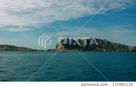 Rocky island with jagged peaks Rocky island with jagged peaks 135993129