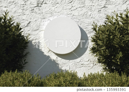 Blank Round Wall Sign Mockup Mounted on Smooth White Wall Surrounded by Greenery and Plants Blank Round Wall Sign Mockup Mounted on Smooth White Wall Surrounded by Greenery and Plants 135993391