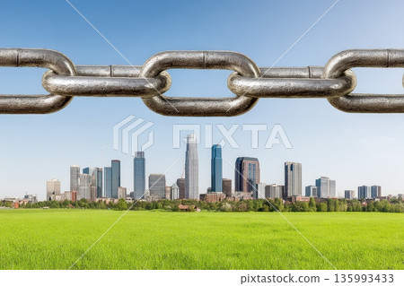 Metallic Chain Links Floating Above a Green Field and City Skyline Under a Clear Sky Metallic Chain Links Floating Above a Green Field and City Skyline Under a Clear Sky 135993433