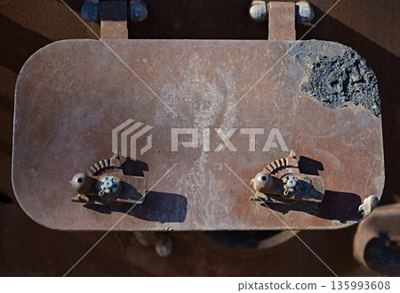 A fragment of the hull of a Russian armored personnel carrier with an armored hatch covered in rust, traces of thermal impact 135993608