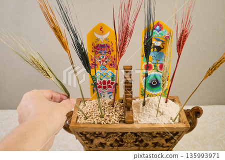 Person arranging chemar box with barley and tsampa 135993971