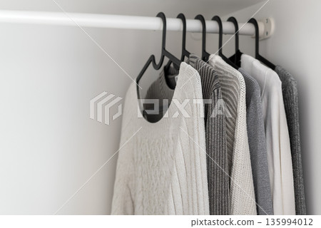 Minimalist wardrobe with neatly arranged knit clothes 135994012